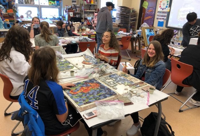 Waterford High School students working on their mosaics. These will be attached to pavers that will create the walking paths of the labyrinth.