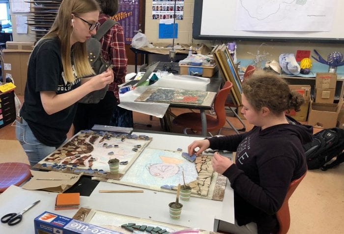 Two students working on their mosaics