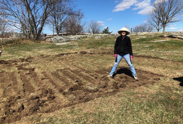 Mary gladly takes a photo op break from rolling sod.