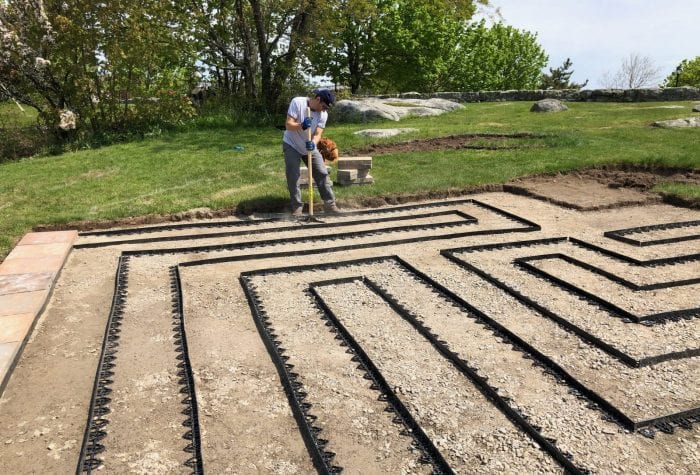Jeff hand-tamps any aggregate that was loosened during the edging process. Now ready for Coast Guard volunteers to help carry pavers over!
