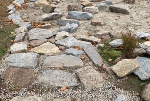 The stone walkway from sidewalk to sandpit